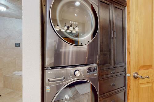 a washing machine in a kitchen with a mirror at Hidden Creek Retreat in Park City