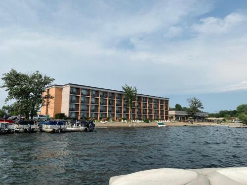 a hotel on the shore of a body of water at Holiday Inn Detroit Lakes by IHG in Detroit Lakes