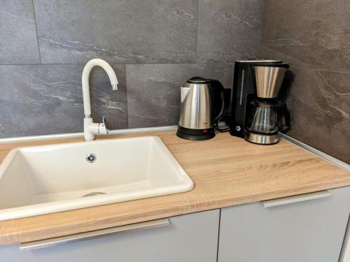 a kitchen counter with a sink and a coffee maker at Ferienwohnung 50m2 in Hilchenbach