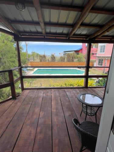 a deck with a view of a swimming pool at Altos de Kiyu in José Ignacio