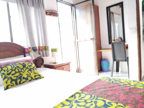 a bedroom with a bed and a large window at Etnias Hotel tematico in Quibdó
