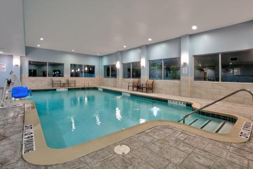 a large swimming pool in a hotel at Holiday Inn Express & Suites North Dallas at Preston by IHG in Dallas