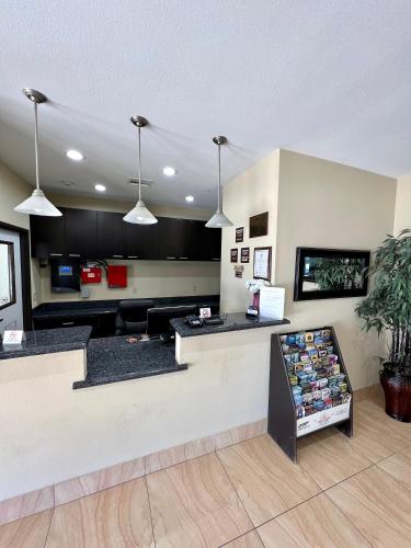 a waiting area of a store with a counter and lights at Americas Best Value Inn Sulphur in Sulphur