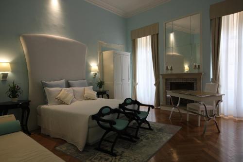 a bedroom with a bed and a desk and a fireplace at Hotel Bologna ***S in Verona
