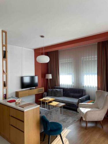 a living room with a couch and a table at Sara’s Stars Apartment in Gjakova in Gjakove