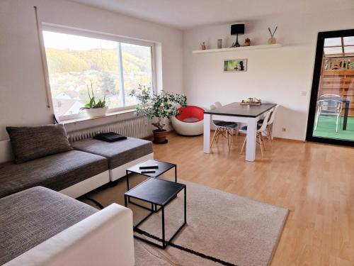 a living room with a couch and a table at Seestudio mit toller Aussicht am Bodensee in Bodman-Ludwigshafen