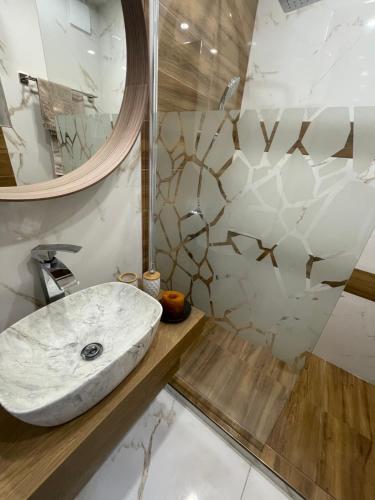 a bathroom with a sink and a mirror at Boutique apartment Bansko Bell Tower in Bansko