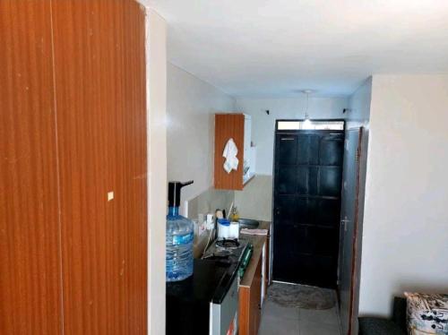 a kitchen with a black refrigerator and a black stove at Quiet and affordable home in Kikuyu