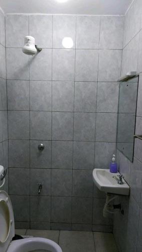 a bathroom with a toilet and a sink at Quiet and affordable home in Kikuyu