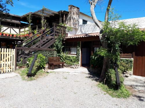 a house with a staircase and a bench in front of it at Complejito El Pichon in La Paloma