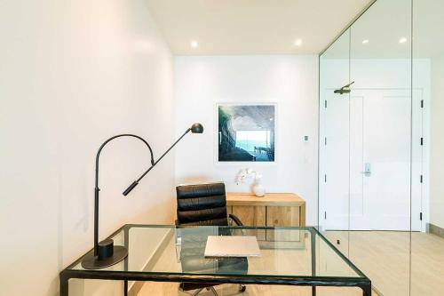 a glass table and a chair in a room at H2O LifeStyle Resort in Long Bay Hills