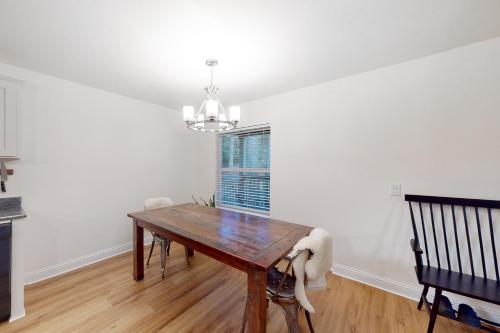 a dining room with a wooden table and a window at Goat Hill in Sebastopol