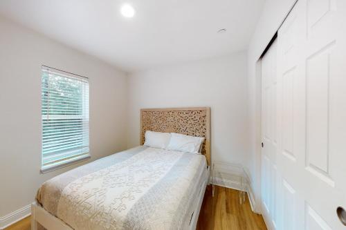 a bedroom with a bed and a window at Goat Hill in Sebastopol