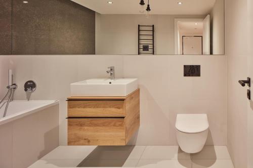 a bathroom with a white sink and a toilet at Designer Apartments in Smíchov by Prague Days in Prague
