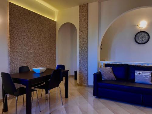 a living room with a table and a couch at Villa Pignatelli in Bari