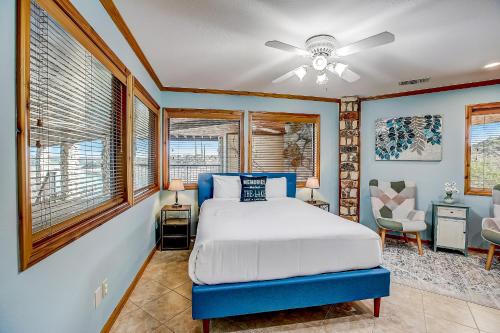 a bedroom with a bed and a ceiling fan at Stone Lodge in Spicewood