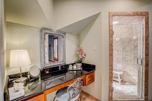a bathroom with a sink and a mirror at Stone Lodge in Spicewood