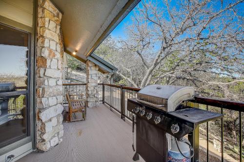 a grill on the balcony of a house at Stone Lodge in Spicewood