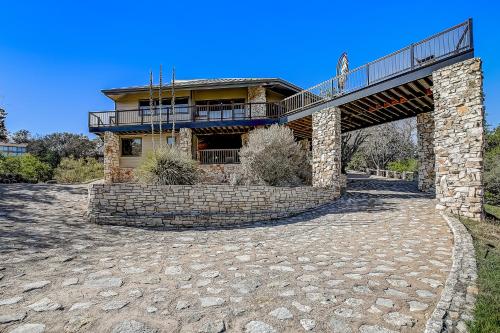 a house with a balcony on top of a bridge at Stone Lodge in Spicewood