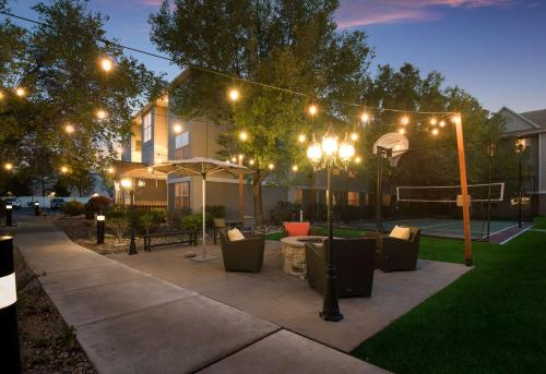 a patio with tables and chairs at night with lights at Sonesta ES Suites Reno in Reno