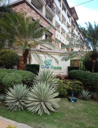 a one oasis sign in front of a building at Cozy 2BR with FREE Pool beside SM City Mall in Davao City