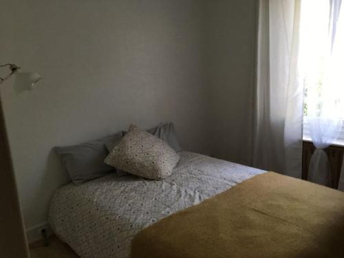 - une chambre avec un lit doté d'un oreiller et d'une fenêtre dans l'établissement Superbe appartement, résidence familiale, parking, à Chevilly-Larue