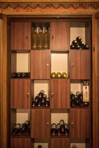 a wooden cabinet filled with lots of bottles of wine at Hotel Fabris in Nova Friburgo