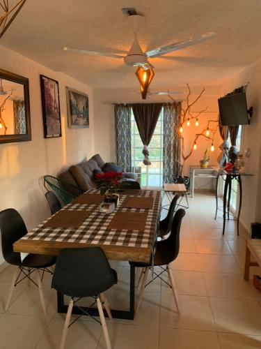 a living room with a table and a couch at sweet home ixtapa comfort in Ixtapa