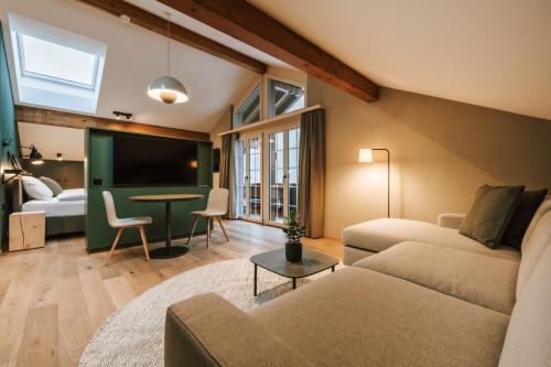 a living room with a couch and a table at Hotel Fiescherblick in Grindelwald