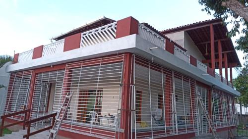 a building with a dog in a cage at Recanto ViVa - Catuama in Goiana