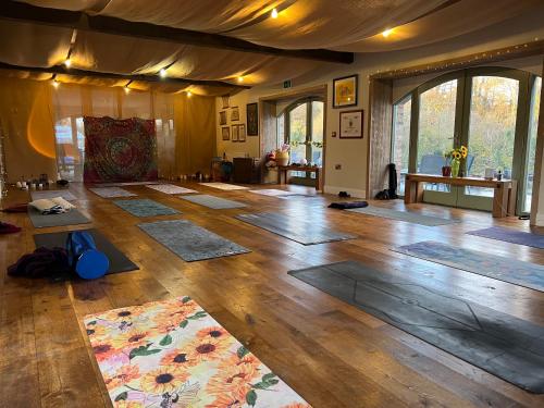 a large room with many yoga mats on the floor at The Old Flax Mill Yoga Retreat in Coleraine