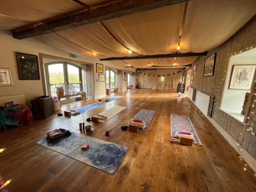 an empty living room with mats on the floor at The Old Flax Mill Yoga Retreat in Coleraine