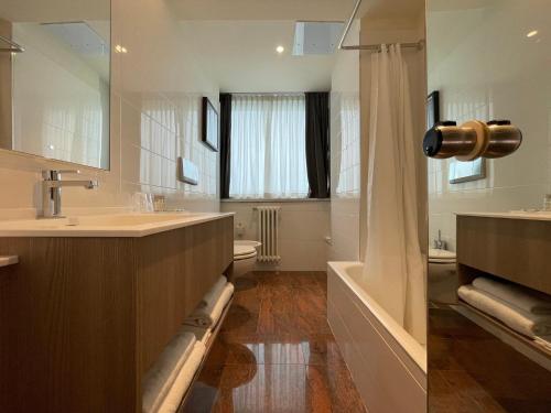 a bathroom with a sink and a tub and a shower at Crowne Plaza Milan Linate, an IHG Hotel in San Donato Milanese