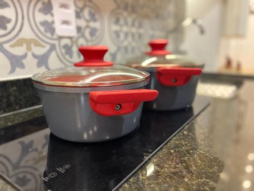 three pots sitting on top of a counter at Recanto Novo Premium Flat in Cabo Frio