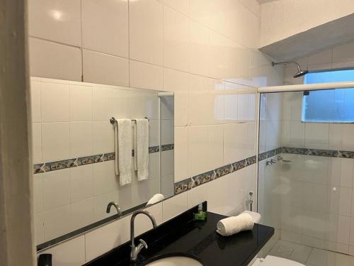 a bathroom with a sink and a shower at Departamento Dos reis in Búzios