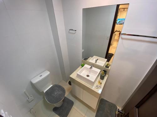 a small bathroom with a toilet and a sink at Recanto Novo Premium Flat in Cabo Frio
