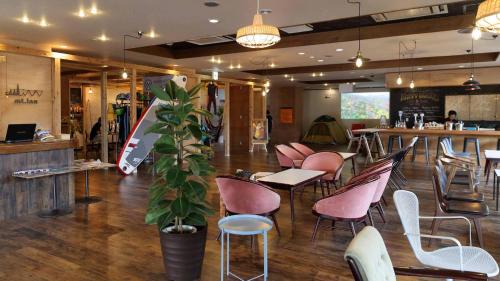 a restaurant with chairs and tables and a bar at mt. inn(マウントイン） in Nihommatsu