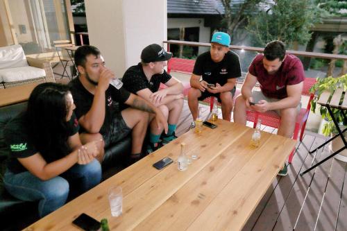 a group of people sitting around a wooden table at mt. inn(マウントイン） in Nihommatsu