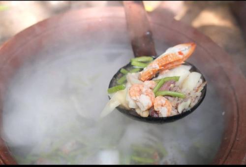 un bol de nourriture avec des crevettes et des légumes sur une table dans l'établissement Malabar home stay, à Jaffna