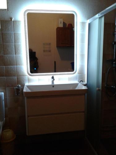 a bathroom with a sink and a mirror at Villa Obaki in Sainte-Anne