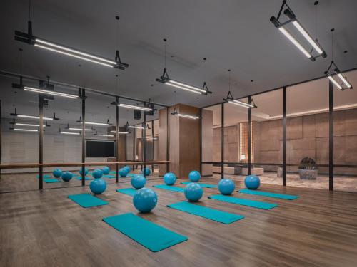 a yoga room with blue pilates balls on the floor at HUALUXE Kunshan Huaqiao by IHG - F1 Racing Preferred Hotel in Kunshan