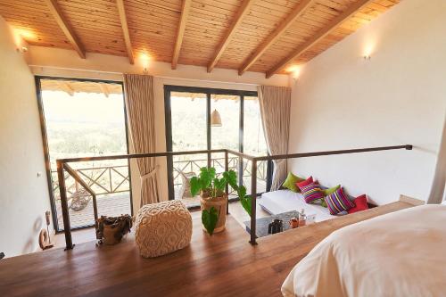 a bedroom with a bed and a balcony at Wayarumi Skyhotel in Carhuaz