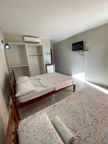 En eller flere senger på et rom på Pousada Do Vozinho