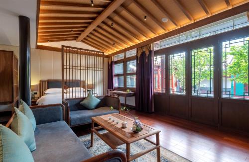 a living room with a couch and a table at Beijing Heyuan Courtyard Hotel (Forbidden City) in Beijing