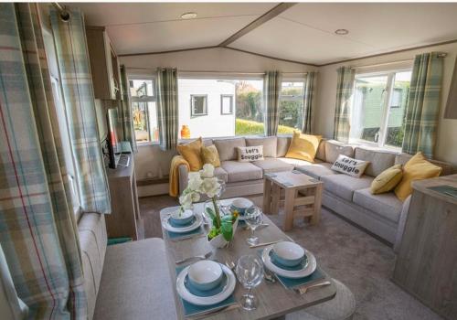 a living room with a couch and a table at Pepper Pot Lodge in Knaresborough