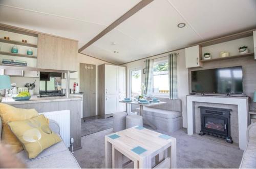 a living room with a couch and a fireplace at Pepper Pot Lodge in Knaresborough