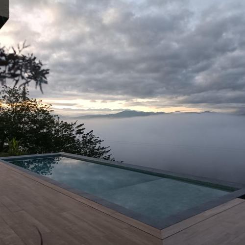 a swimming pool with a view of the water at Casa Río Quindío in La Tebaida
