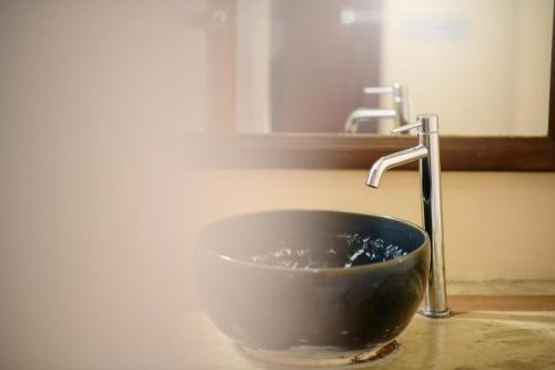 a bowl under a sink with a faucet at Estia Chiangmai in Chiang Mai