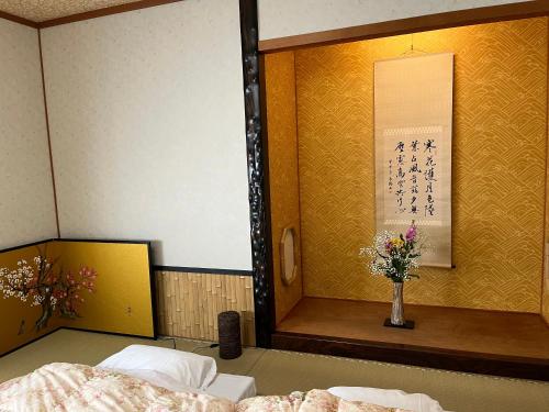 Ένα ή περισσότερα κρεβάτια σε δωμάτιο στο Kyoto Ryokan Gion Sano