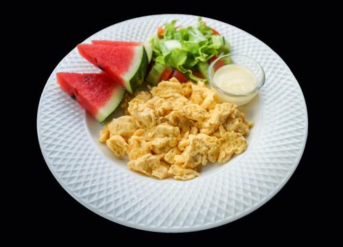 a white plate of food with watermelon and a salad at Pai Homey in Pai